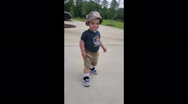 Adorable and cute little toddler walks across bridge to the park
