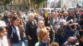 Adults and youngsters protest against child vaccination by throwing colourful balls into Downing Street