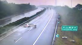 Car spins out of control on wet highway