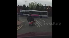 Mobility scooter rider pulls side wheelie in Manchester