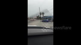 Cars struggle through floodwater in Louisiana, US