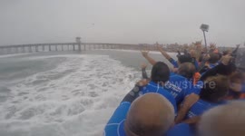 66 Surfers ride record-breaking surfboard