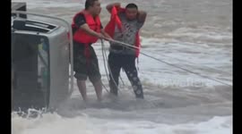 Truck driver rescued from flooded river