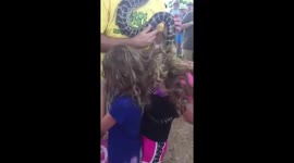 Large python gets tangled in little girls' hair