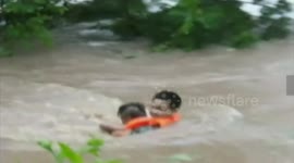 Woman rescued from flooded river in China
