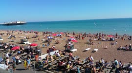 Crowded beach during summer heatwave in Brighton, UK