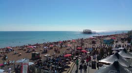 Crowded beach during summer heatwave in Brighton, UK