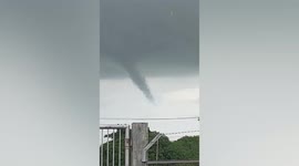 Rare funnel cloud forms over village in the Philippines as monsoon rains batter the country