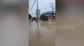 Residents wade through knee-deep floods to buy supplies after monsoon rain in the Philippines