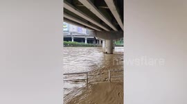 Parked cars submerged in dirty water after heavy rain causes river to overflow in the Philippines