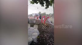 Defiant couple push through wedding ceremony despite heavy rain