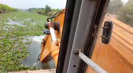 Worker uses excavator arm to 'row' ferry across river in Vietnam