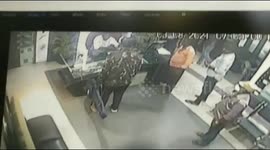 A women walks away without loosing her cool when a stranger is threatening the entire employees of a media house with a big machete in South India