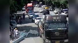 Electric bike rider knocked over by steel pipes falling from truck in China