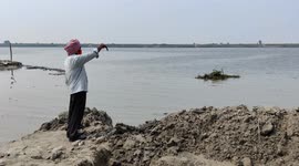 A Man has trying to waran people's to move safe places for heavy rain in bank side Ganga river