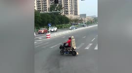 Motorist spotted riding electric bike fitted with car seat in China