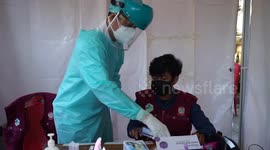 Officers conduct an antigen swab test at the Makassar City Border