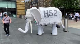 An 'HS2' white elephant goes for a walk during the Stop HS2 protest outside King's Cross station, London, UK