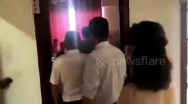 Chinese authorities kick open door as teacher breaks restrictions by gathering students in room for lessons