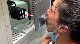 Vehicle with robotic arm inside helps conduct COVID-19 test for residents in central China