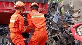 Firefighters rescue motorists trapped in car crushed by two trucks in northern China