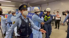 Tokyo police and medics evacuate injured passenger after knife attack on train