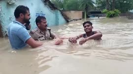 Police officer wades through rising waters to save people from floods in central India