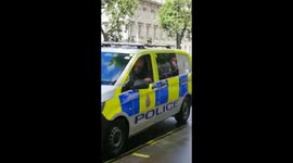 Armed policeman embraces ex comrade at Gurkha demo in Whitehall, London on Sat 7th August 2021