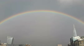 Spectacular rainbow appears over the Thames during heavy rain in London