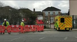 London's air ambulance blows over street of traffic barriers when taking off from an incident