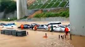Chinese firefighters rescue motorists trapped in cars submerged in deep floodwater