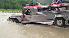 Overloaded bus crosses river after heavy rain in the Philippines