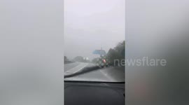 Heavy rains from typhoon Lupit drench roads in China