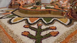 Stone sculpture at Hindu temple decorated by lentils and rice in India