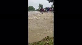 Indian man tries to ride motorbike through flooded river with disastrous results