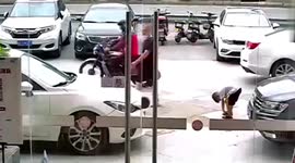 Vehicle runs over boy bending down to tie shoelaces in southern China