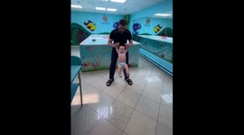 Gymnastics for an infant by a professional specialist