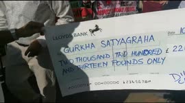 Gurkha demo in London. Gurkhas presented with a large cheque in support of their demo outside Downing Street in London