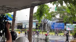 Protesters hit with tear gas during clashes with police in Bangkok, Thailand