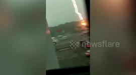 Dramatic lighting bolt scares woman as she records storm in eastern China