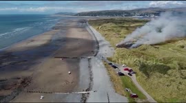 Holidaymakers shocked to see sand dunes on FIRE in Welsh seaside resort following UK heatwave
