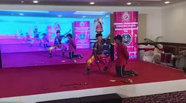 Blindfolded folk artist cuts banana with sword on man's mouth in southern India