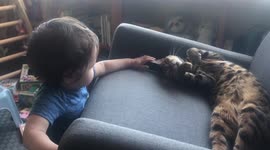 Baby Boy pets his big sister Ella the bengal cat while he mimics her meow