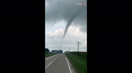 Storm chaser captures close up footage of tornado crossing road in Illinois