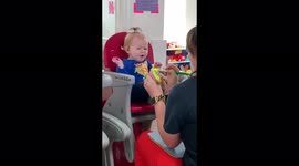 Baby in Florida makes funny faces while getting her feet painted