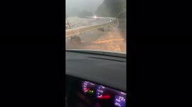 Raging river threatens to swamp road in Saga, Japan, amid widespread flooding