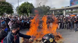 Anti-government protesters light bonfire on road during Bangkok rally