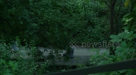 People spend time in park Blandan during the summer heat in Lyon, France