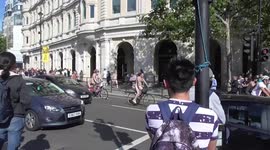 NAKED BIKE RIDE ONE MAN PUSHES HIS BIKE NAKED A CROSS THE ROAD FROM TRAFALER SQUARE