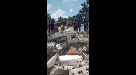 Rescuers search rubble of collapsed buildings after earthquake hits Haiti